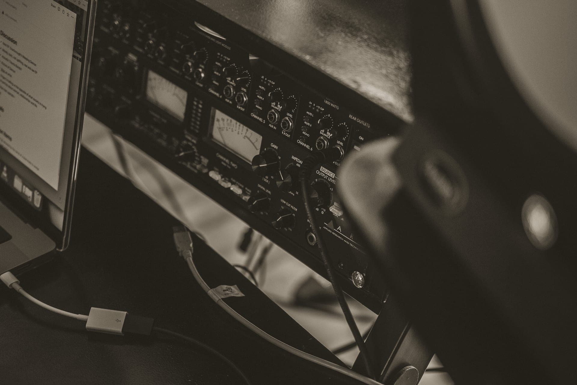 A compact desktop digital-to-analogue converter on a dark wooden surface